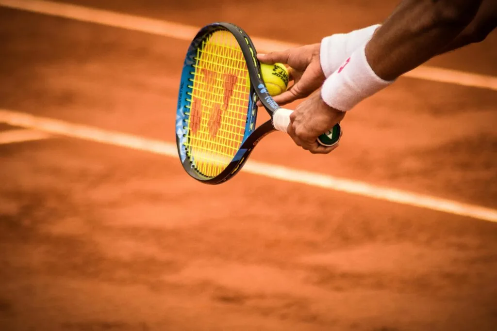 pexels-photo-1432039-1432039 Close-up of a tennis player preparing to serve on a clay court in Montevideo.