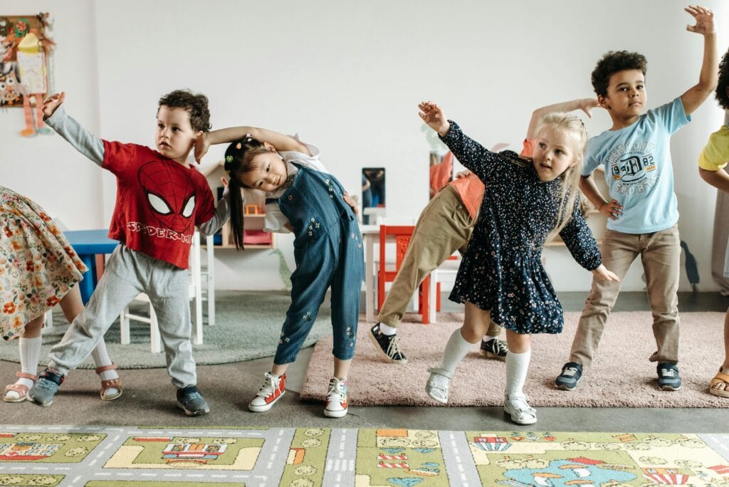 pexels-photo-8422104-8422104 Group of diverse preschool children engaging in fun exercises indoors.