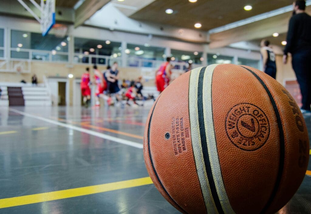 Captivating indoor basketball scene with players actively engaged in a game.